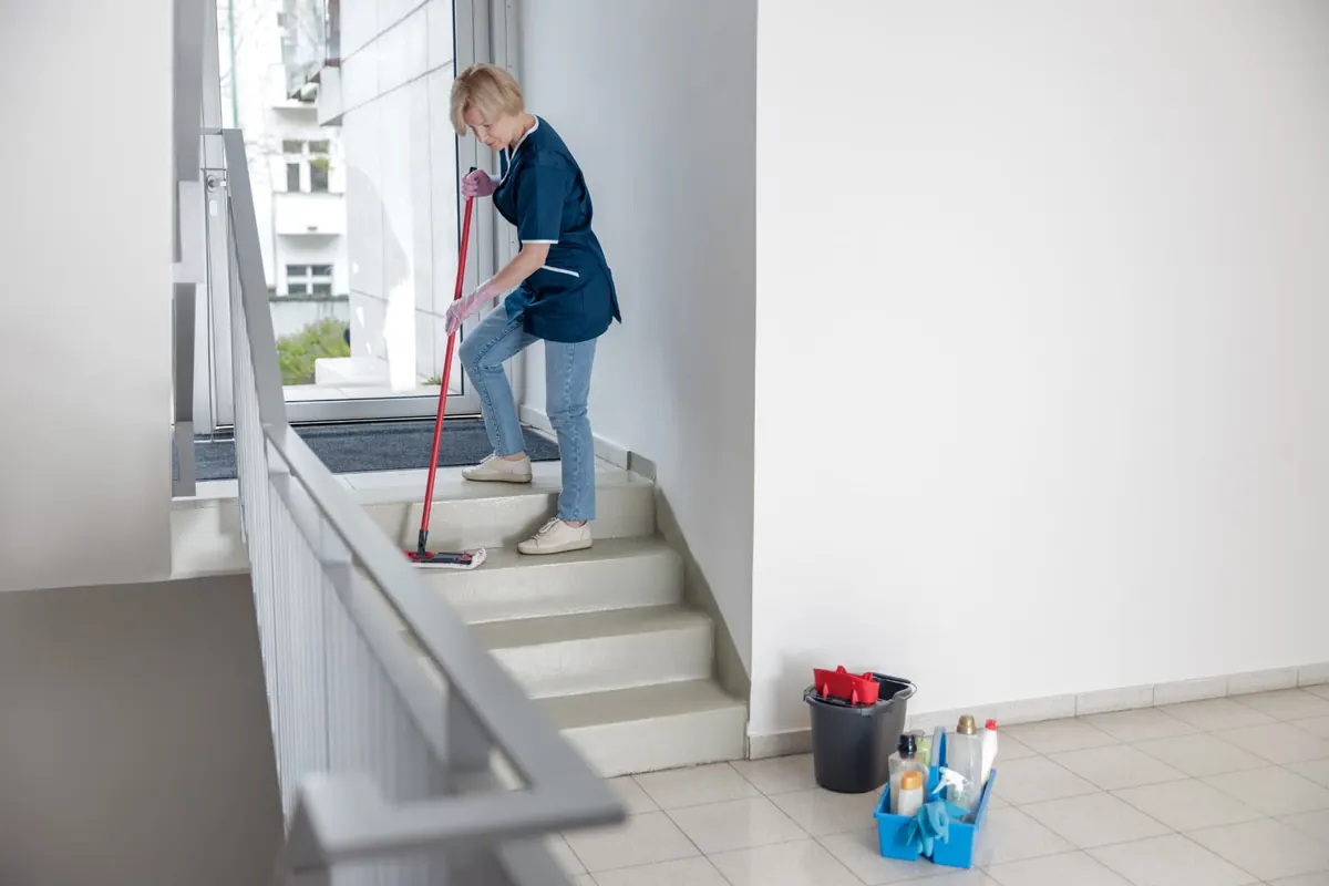 Allstars team member cleaning a building staircase